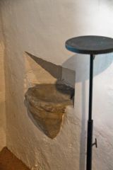 A very simple piscina in the chancel wall