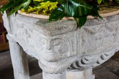 A carved head on the font bowl