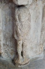 Figure of a woodwose on the font stem