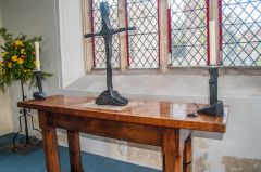 Driftwood altar cross atop a medieval supermensa