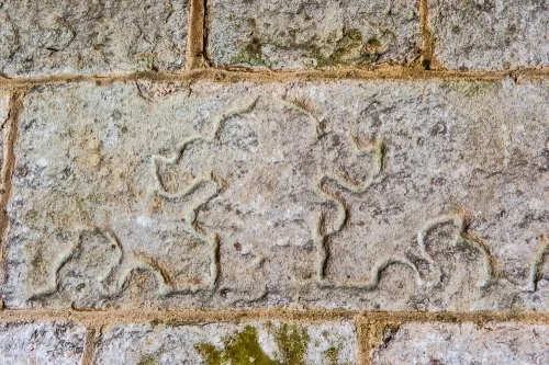 Section of a Norman cross slab in the wall