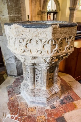 The early 14th-century font and medieval tiles