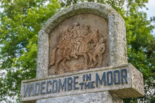 The village sign, showing Uncle Tom Cobley and all riding the mare
