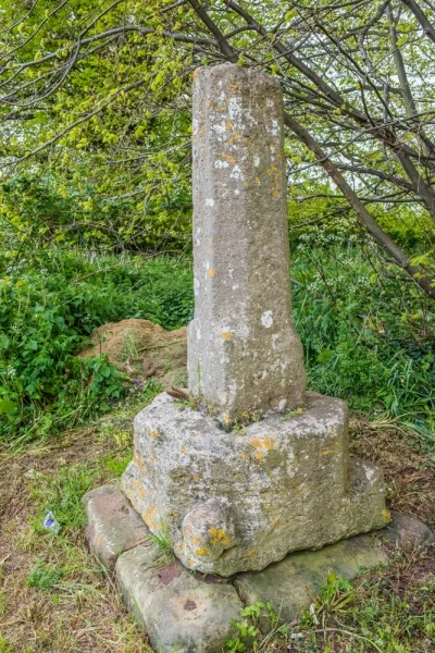 13th-century cross opposite the church