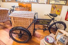 A tricycle delivery cart with a willow basket