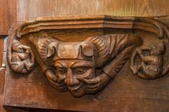 Misericord of a man making a grotesque face