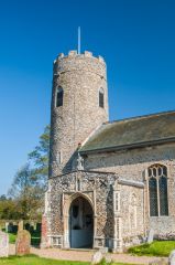 The 12th century round tower and 14th century porch