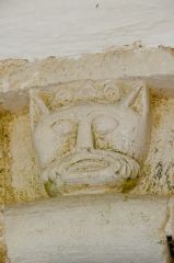 A grotesque head on the south doorway arch
