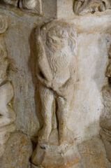 Figure of a woodwose on the font stem