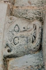 Grotesque carved head on the south doorway