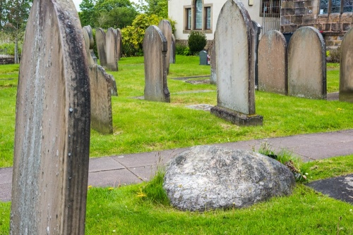 The grave lies beside the churchyard path