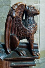 Medieval bench end of a winged figure