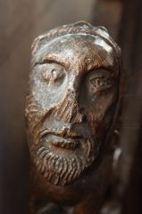 Medieval bench end of a man's head