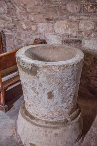 The plainly carved tub font