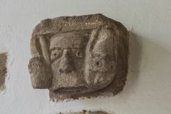 Medieval carved head on the chancel wall
