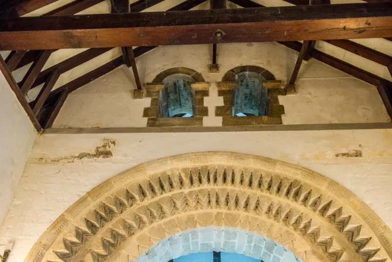 The Norman chancel arch with two small round-headed arches above