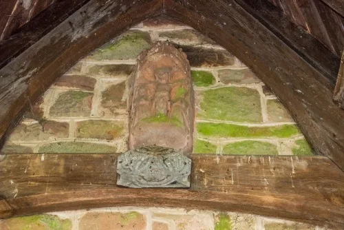 Medieval stone crucifixion carving over the south door