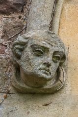 Carved head on the south facade