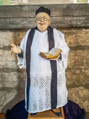 Figure of Father Brown inside the church