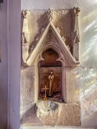 The 13th-century piscina, south aisle