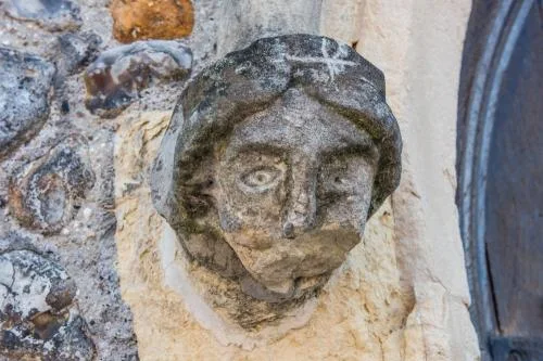 Carved head, west doorway