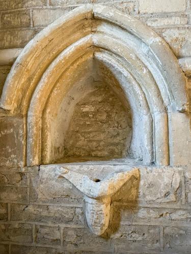 12th-century piscina and corbel head