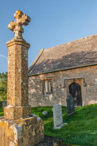 Churchyard memorial cross and south door