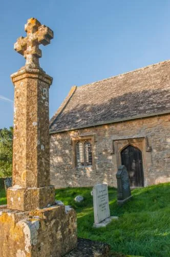 Churchyard memorial cross and south door