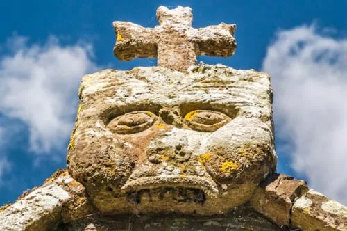 Grotesque carving over the porch