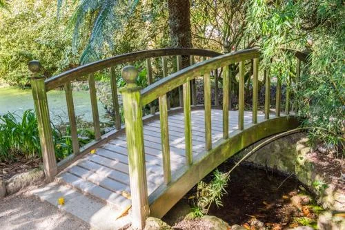 A picturesque footbridge crosses a stream