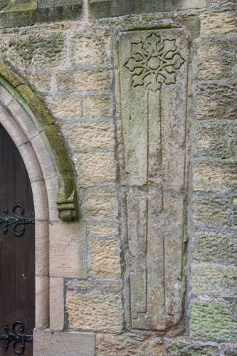 Medieval cross slab set into the exterior wall