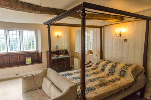 A partially restored four-poster bed on the first floor