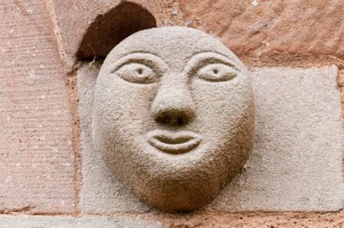 Carved head, church exterior