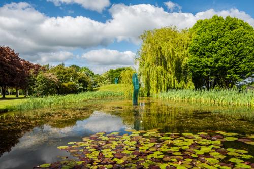Modern sculpture in the garden pond