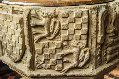 Intricately carved coat of arms on the font