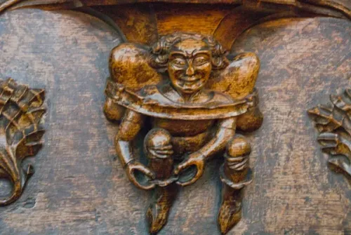 A pedlar pulling on his boot