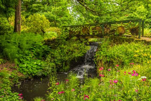 A footbridge passes over a small cascade