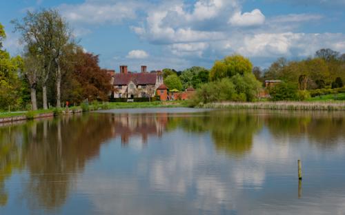 Packwood House reflected in the Great Pool
