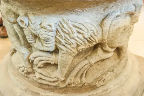 Carved lion figure on the font