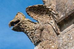 Grotesque carving on the west wall
