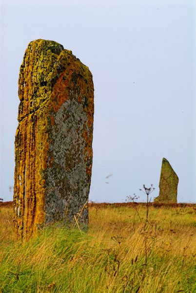 The Comet Stone, an outlying standing stone with two nearby smaller stones. It has been suggested that the Comet Stone forms part of an avenue leading to the circle. Photo of the Ring of Brodgar, Orkney Mainland, Scotland.