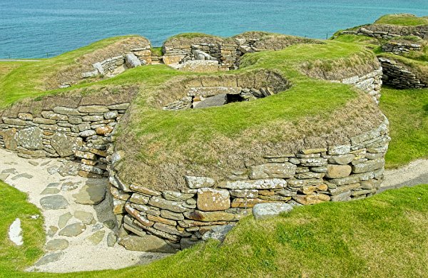 The World Heritage site of Skara Brae is one of Orkney's premier visitor attractions. Though you cannot go inside the huts, you can look down into them from the path through the site. Photo of the Orkney Islands, Scotland.
