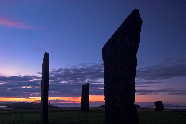 The Stones of Stenness silhouetted against the sunset sky. Here you can clearly see the sloping right to left angle of the larger stones. Photo of the Orkney Islands, Scotland.
