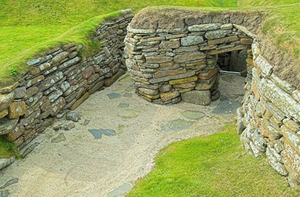 Hut entrance. Mind your head! Photo of Skara Brae, a prehistoric village on the Orkney Islands, Scotland.