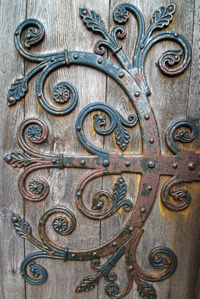Decorative iron strapwork with foliage supporting the medieval west aisle door. Photo of St Magnus Cathedral, Kirkwall, Orkney Islands, Scotland.