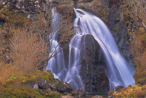 Waterfalls in Glen Brittle, near the Fairy Pools. I love the colours in this photo. The water is a misty blue-purple that contrasts with the bronze of the vegetation. Stock photo of Glen Brittle on the Isle of Skye, Scotland. Part of the Britain Express Travel and Heritage Picture Library, Scotland collection.