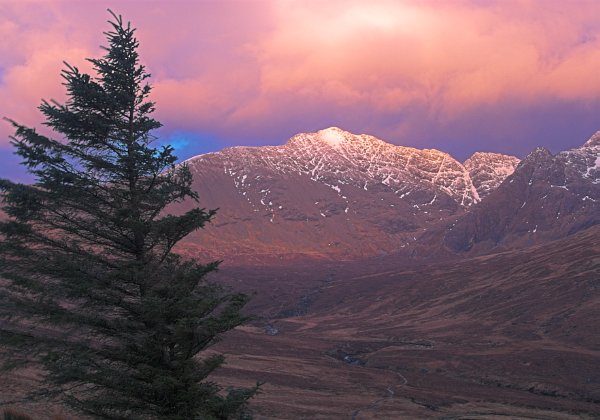 Flaming clouds light up the Cuillin Hills. Stock photo of the Cuillin Hills on the Isle of Skye, Scotland. Part of the Britain Express Travel and Heritage Picture Library, Scotland collection.