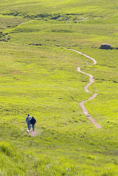 Walkers enjoy the path along Alt Coir' a' Mhadaidh near the Fairy Pools. Photo of Glen Brittle, on the Isle of Skye, Scotland. Part of the Britain Express Travel and Heritage Guide.