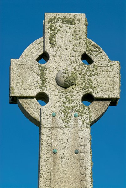 A close-up photograph of Jacobite heroine Flora MacDonald's memorial cross. The cross is celtic in style and simply decorated. At Kilmuir cemetary, Isle of Skye, Scotland.