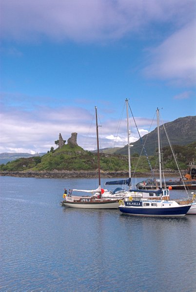 Yachts anchored in the harbour in Kyleakin. The ruins of Castle Maol can be seen on a knoll in the background. Stock photo of Kyleakin on the Isle of Skye, Scotland. Part of the Britain Express Travel and Heritage Picture Library, Scotland collection.